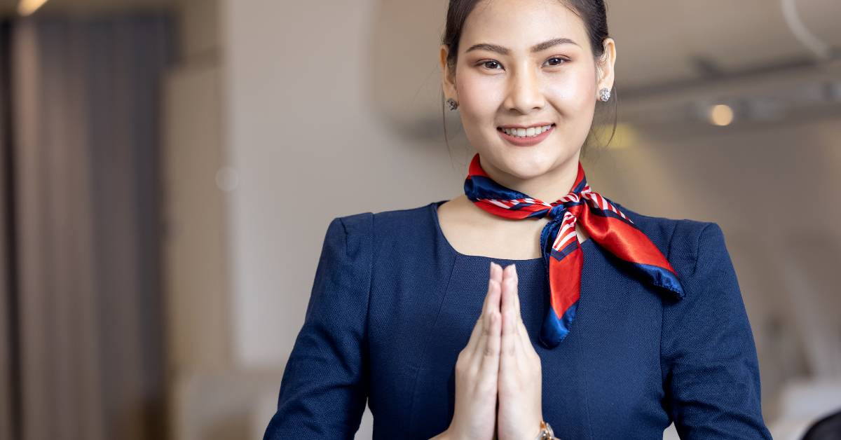 Cabin crew or Stewardess greeting passengers on airplane