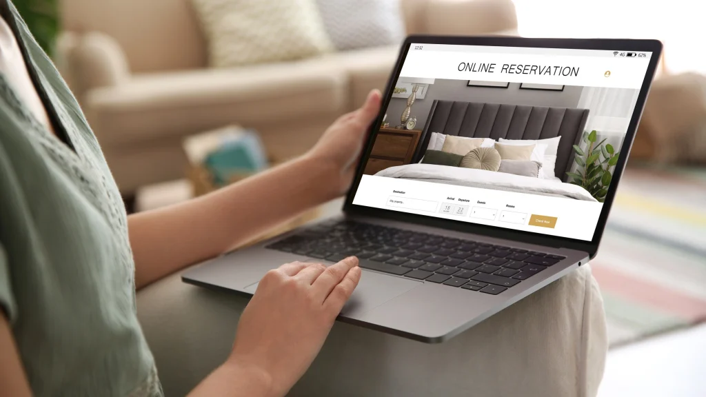 Someone browsing an accommodation booking page on a laptop.